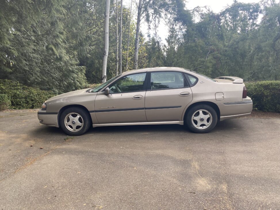 gold 2001 Chevy Impala up for online auction with blue nest home in Silverdale Washington.