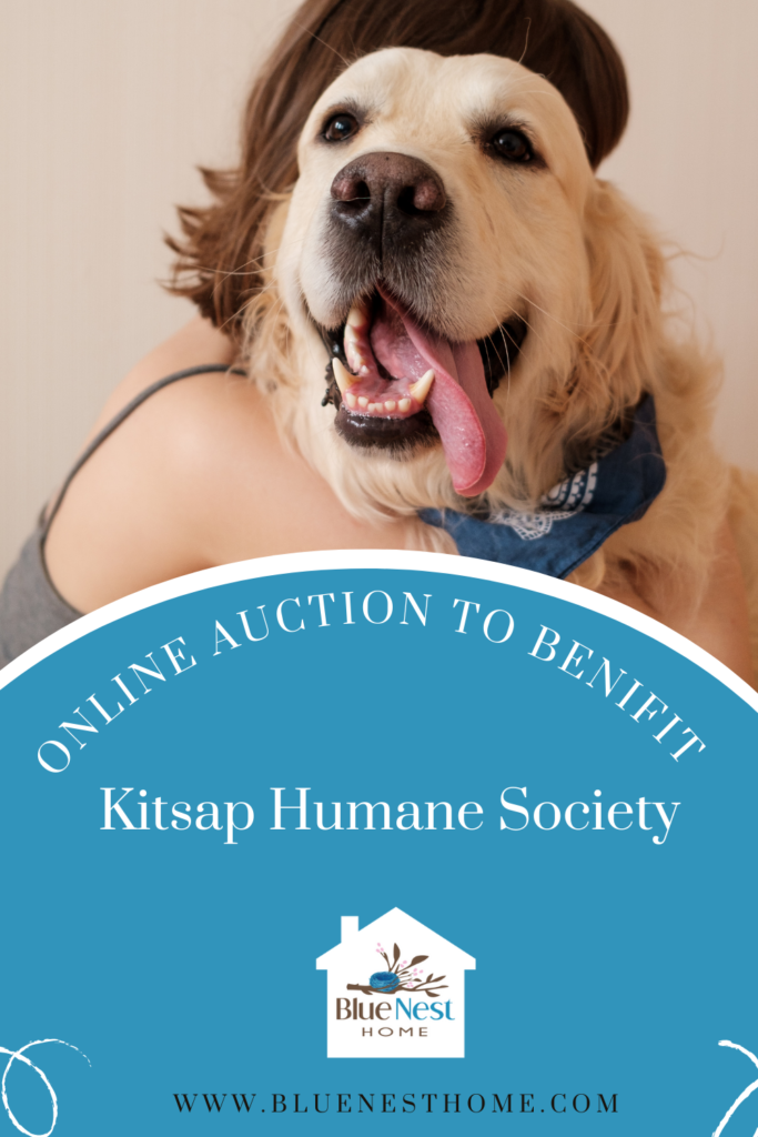 A woman hugging a golden retriever dog with the words online auction to benefit the Kitsap Humane society